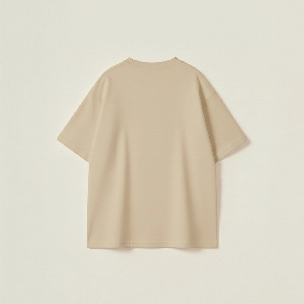 Beige oversized t-shirt for men with white slogan typography and a relaxed drop-shoulder urban fit.