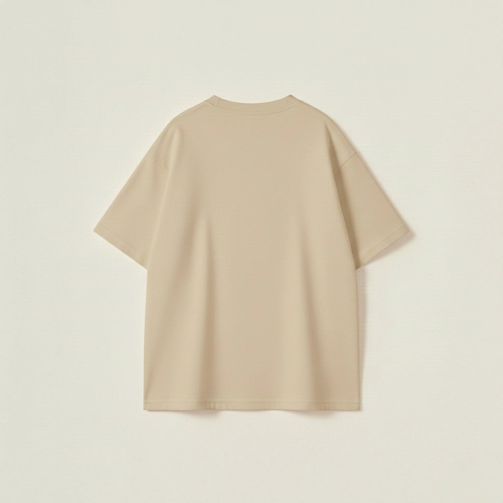 : Beige oversized crew neck tee for men featuring a raised black Porsche slogan in a loose fit.