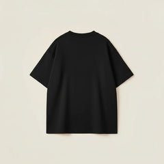 Men’s oversized black cotton t-shirt with drop shoulder fit and bold varsity typography design.
