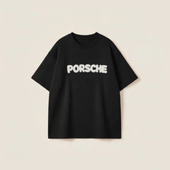 Men’s black oversized cotton t-shirt with white Porsche 3D puff print graphic on the chest.