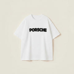 Oversized white t-shirt for men featuring black Porsche puff print logo on chest with a relaxed street style fit.