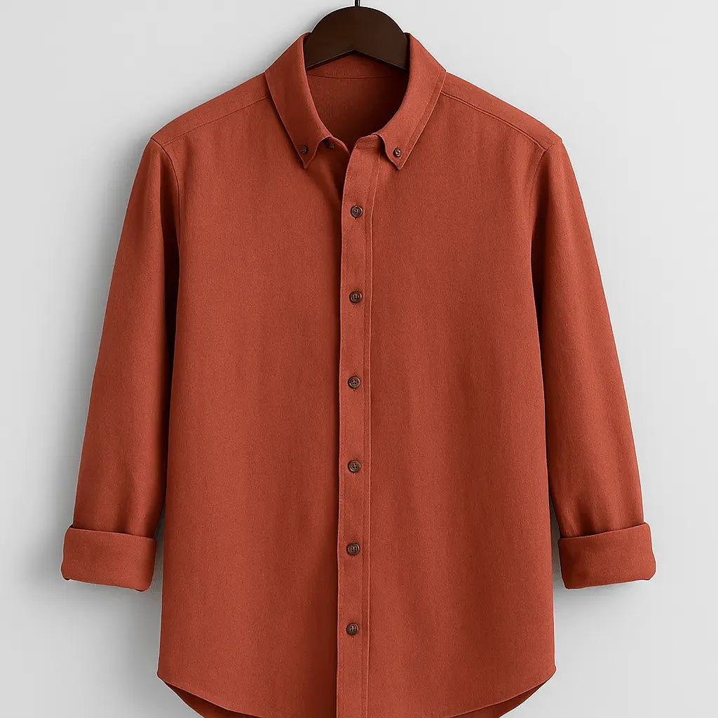 Men's burnt orange textured full sleeve shirt with button-down collar, displayed front-on, hanging from a wooden hanger against a white background.