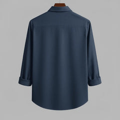 Men's deep navy textured full sleeve shirt, back view, hanging on a wooden hanger against a neutral grey background, showing the relaxed fit and textured fabric.