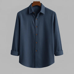 Men's deep navy textured full sleeve shirt with wooden buttons, front view, hanging on a wooden hanger against a neutral grey background.