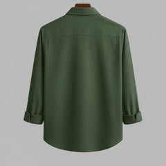 Men's olive green textured full sleeve shirt, back view, displayed on a wooden hanger against a grey background, showcasing the relaxed fit and texture.