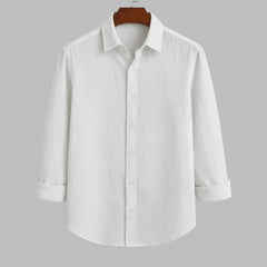 Men's pure white textured full sleeve shirt, front view, hanging on a dark wooden hanger against a light grey background